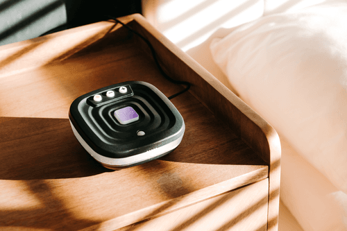 Photo of the Bide device on a wooden bedside cabinet