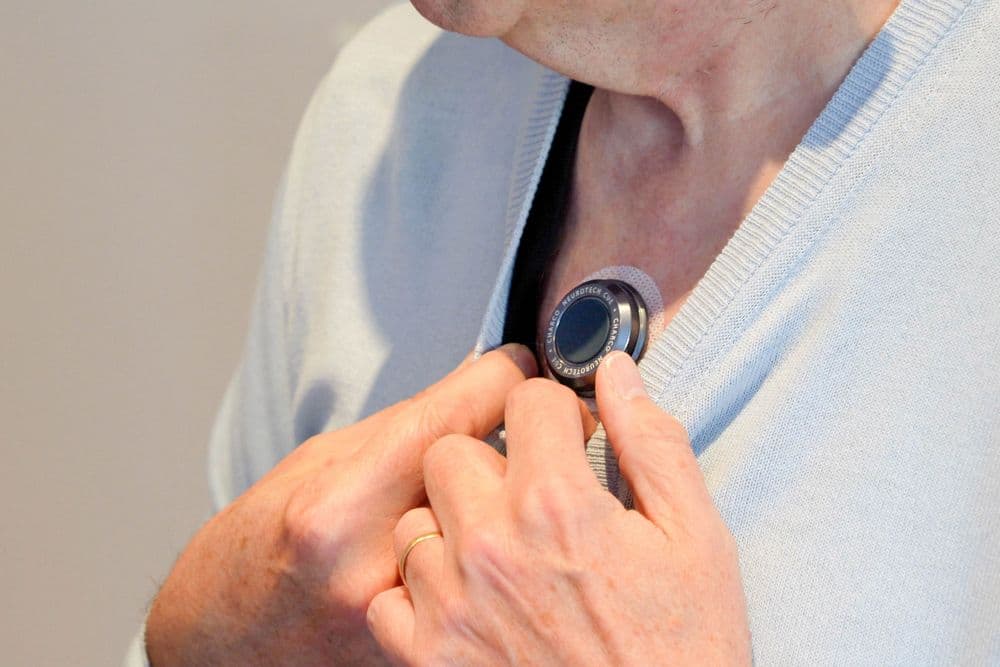 Photo of someone wearing the CUE1+ device on their chest.