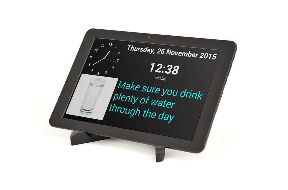 A photo of the myhomehelper device. On the screen, it shows the time and there is a reminder for the user to drink water.