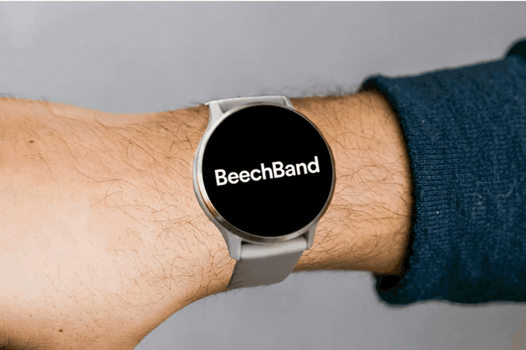 A wrist wearing an Android smartwatch. The word BeechBand is written in white on the black screen.