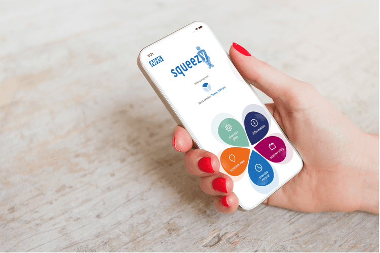 A photo of a white hand with red nails holding a smartphone above a table. You can see the homepage of the Squeezy app on the phone screen.